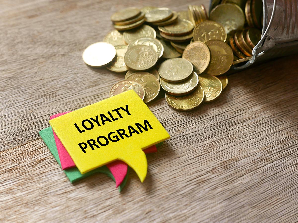 Coins next to sign saying loyalty program.