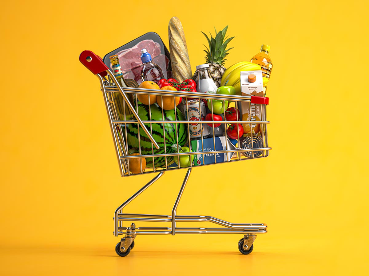 A full shopping cart loaded with groceries