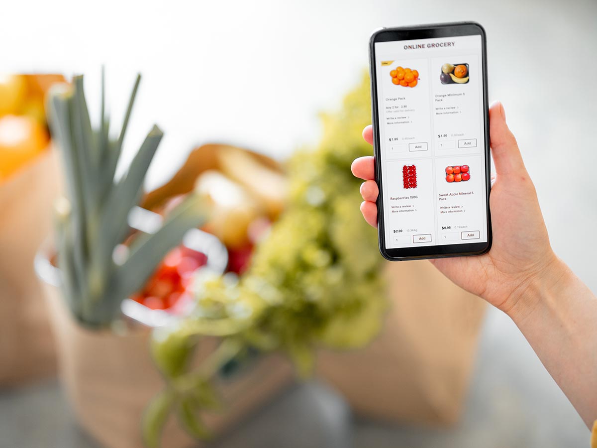 Person looking at grocery store website on phone.