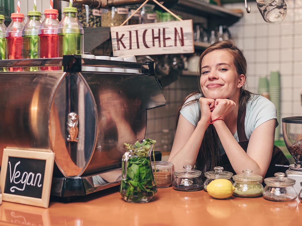 Restaurant worker smiling at counter.