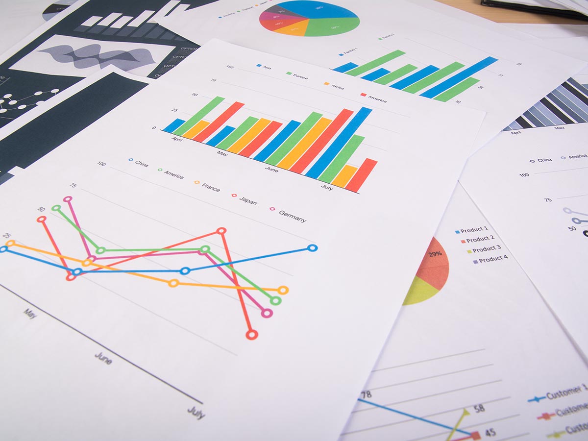 Several loose pieces of paper showing graphs and reports.