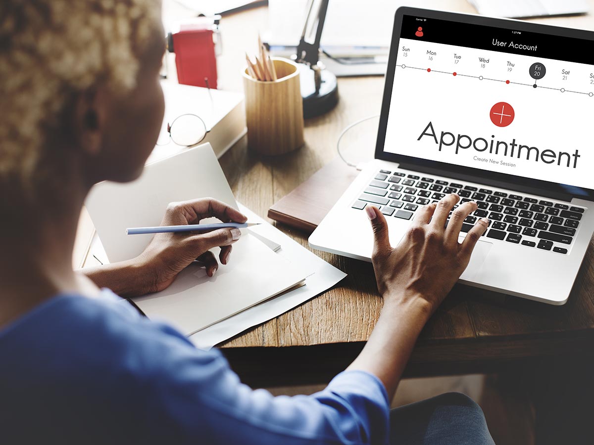 Woman on laptop making an appointment online.